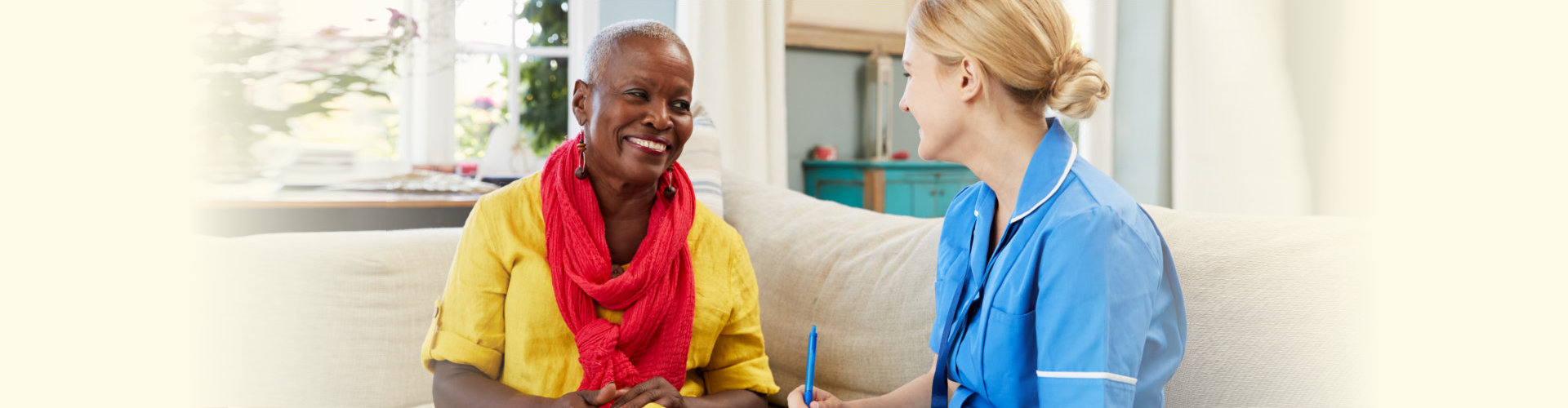 caregiver talking to a senior woman